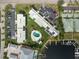 Overhead shot of condo complex, showcasing the pool, boat docks, parking areas, and solar panels on roofs at 1461 Aqui Esta Dr # B3, Punta Gorda, FL 33950