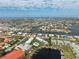 Overhead shot of waterfront homes and condos with community pool and boat docks on a sunny day at 1461 Aqui Esta Dr # B3, Punta Gorda, FL 33950