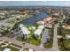 Scenic aerial view of a waterfront condo complex with pool, boat docks, ample parking, and lush landscaping at 1461 Aqui Esta Dr # B3, Punta Gorda, FL 33950