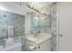 Bathroom with vanity, mirror, and lively floral wallpaper at 1461 Aqui Esta Dr # B3, Punta Gorda, FL 33950