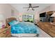 Bedroom with ceiling fan, walkout patio, and beach themed decor at 1461 Aqui Esta Dr # B3, Punta Gorda, FL 33950