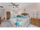 Bedroom with ceiling fan, walkout patio, and beach themed decor at 1461 Aqui Esta Dr # B3, Punta Gorda, FL 33950
