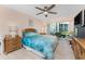Bedroom with ceiling fan, walkout patio, and beach themed decor at 1461 Aqui Esta Dr # B3, Punta Gorda, FL 33950