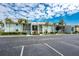 Well-maintained exterior of the condo complex featuring lush landscaping and a large parking lot at 1461 Aqui Esta Dr # B3, Punta Gorda, FL 33950