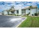 Exterior showcasing the building's facade, lush landscaping, and convenient parking for residents at 1461 Aqui Esta Dr # B3, Punta Gorda, FL 33950