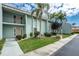 Inviting condominium featuring a well-manicured lawn with several palm trees at 1461 Aqui Esta Dr # B3, Punta Gorda, FL 33950