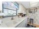 Bright kitchen with double sink, natural light, and modern white appliances at 1461 Aqui Esta Dr # B3, Punta Gorda, FL 33950