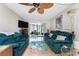 Bright living room with hardwood floors, comfortable sofas, a ceiling fan, and a view of the outdoor lanai at 1461 Aqui Esta Dr # B3, Punta Gorda, FL 33950