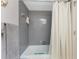 Bathroom shower/tub combo with tile surround and white curtain at 1461 Aqui Esta Dr # B3, Punta Gorda, FL 33950