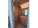 Bathroom features a vanity with granite countertops, tile floors, and a large mirror at 14970 Appleton Blvd, Port Charlotte, FL 33981