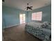 Bright bedroom with carpet, ceiling fan, and sliding glass doors to the patio at 14970 Appleton Blvd, Port Charlotte, FL 33981