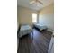Bedroom with two twin beds and dark floors and light walls at 14970 Appleton Blvd, Port Charlotte, FL 33981