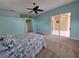 Light-filled bedroom with carpet, ceiling fan, and sliding glass doors at 14970 Appleton Blvd, Port Charlotte, FL 33981
