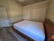Bedroom with wood floor and white walls and large closet space, with a bed at 14970 Appleton Blvd, Port Charlotte, FL 33981