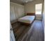 Bedroom with wood floor and white walls and large closet space, with a bed at 14970 Appleton Blvd, Port Charlotte, FL 33981