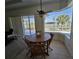 Breakfast nook featuring large windows with water views and a wooden table with chairs at 14970 Appleton Blvd, Port Charlotte, FL 33981