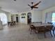 Open-concept dining room with tile floors, a ceiling fan, and lots of natural light at 14970 Appleton Blvd, Port Charlotte, FL 33981