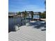 Waterfront dock with boat lift overlooking canal with reeds and neighboring houses on a sunny day at 14970 Appleton Blvd, Port Charlotte, FL 33981
