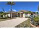 Charming home with a brick driveway, well-manicured landscaping, and a three-car garage at 14970 Appleton Blvd, Port Charlotte, FL 33981