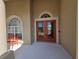Inviting front entrance with a covered porch and double glass doors at 14970 Appleton Blvd, Port Charlotte, FL 33981