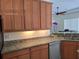 Kitchen area features granite countertops and wood cabinets at 14970 Appleton Blvd, Port Charlotte, FL 33981