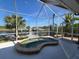 Enclosed lanai with water views and a spa at 14970 Appleton Blvd, Port Charlotte, FL 33981