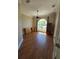 Bright living room featuring hardwood floors, ceiling fan, and a large window offering plenty of natural light at 14970 Appleton Blvd, Port Charlotte, FL 33981