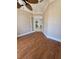 Open living room featuring hardwood floors, crown molding, and double doors leading to another room at 14970 Appleton Blvd, Port Charlotte, FL 33981