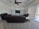 Spacious living room features a ceiling fan, recessed lighting, and sliding glass doors at 14970 Appleton Blvd, Port Charlotte, FL 33981
