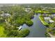 An aerial view of the property, canal, and private dock, highlighting the lush landscaping and waterfront living at 150 N Oxford Dr, Englewood, FL 34223