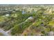 Wide aerial perspective displaying a property nestled amidst a natural setting with nearby waterways at 150 N Oxford Dr, Englewood, FL 34223