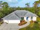 Aerial view of house showcasing roof, driveway, and landscaping at 150 N Oxford Dr, Englewood, FL 34223