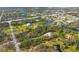 A serene aerial view showcasing the home's lush surroundings and waterfront access at 150 N Oxford Dr, Englewood, FL 34223