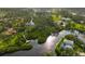 Aerial view featuring a property with canal access and private dock, surrounded by dense greenery at 150 N Oxford Dr, Englewood, FL 34223