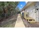Exterior view featuring a walkway leading to a private back deck and fenced yard at 150 N Oxford Dr, Englewood, FL 34223
