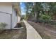 A concrete path meanders through the fenced backyard, adding to the landscape at 150 N Oxford Dr, Englewood, FL 34223