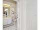 Bright bathroom featuring white fixtures, tiled floors, and a modern vanity at 150 N Oxford Dr, Englewood, FL 34223