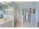 Bright bathroom featuring walk-in shower, large mirror and double sink at 150 N Oxford Dr, Englewood, FL 34223