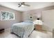 Serene bedroom with tiled floor, light walls, large window, and a ceiling fan at 150 N Oxford Dr, Englewood, FL 34223