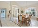 Bright dining room with tile flooring, chandelier, and a view to the front door at 150 N Oxford Dr, Englewood, FL 34223