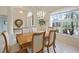 Dining room featuring a wood table, white chairs, and a chandelier hanging above at 150 N Oxford Dr, Englewood, FL 34223