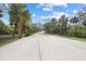 Long private driveway lined with trees, providing a scenic entrance to the property at 150 N Oxford Dr, Englewood, FL 34223