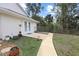 An exterior walkway leads to this beautiful home with access to the backyard at 150 N Oxford Dr, Englewood, FL 34223