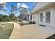Exterior pathway leading to home with a screen enclosed lanai with pool at 150 N Oxford Dr, Englewood, FL 34223