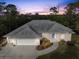 Aerial view of a well-maintained home featuring manicured landscaping and an attached two-car garage at 150 N Oxford Dr, Englewood, FL 34223