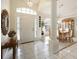 Elegant foyer featuring tile flooring, a chandelier, and a dining area with natural light at 150 N Oxford Dr, Englewood, FL 34223