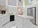 White kitchen with stainless appliances, plenty of cabinet space, and center island at 150 N Oxford Dr, Englewood, FL 34223