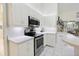 This well-equipped kitchen includes stainless steel appliances, white cabinetry, and an eat-in space at 150 N Oxford Dr, Englewood, FL 34223