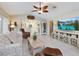 Living room featuring tile floors, comfortable seating, and a modern entertainment center at 150 N Oxford Dr, Englewood, FL 34223