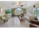 Spacious living room with tile flooring, a large window, ceiling fan, and stylish furnishings at 150 N Oxford Dr, Englewood, FL 34223